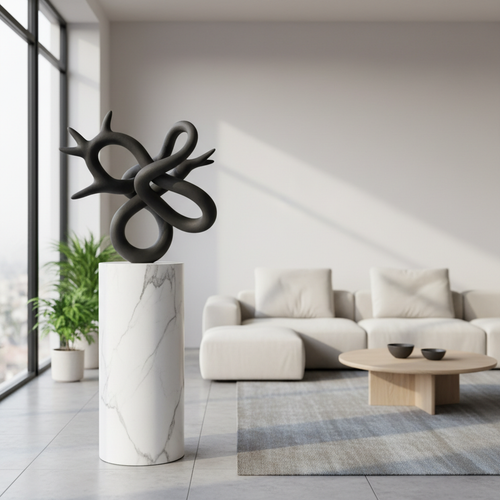 Abstract black ceramic sculpture on marble pedestal
